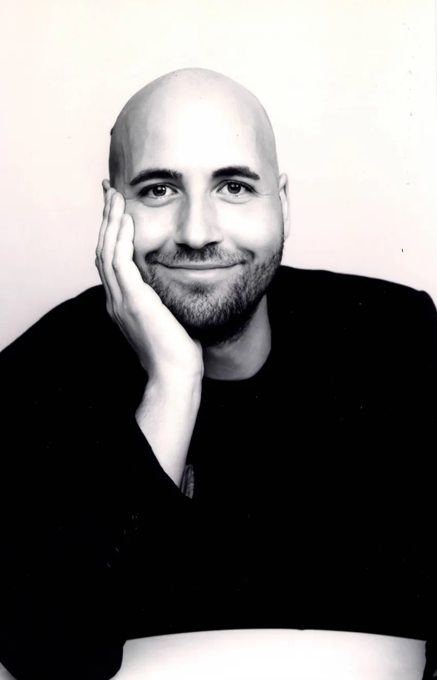 Kevin Veigel smiling in a black and white portrait